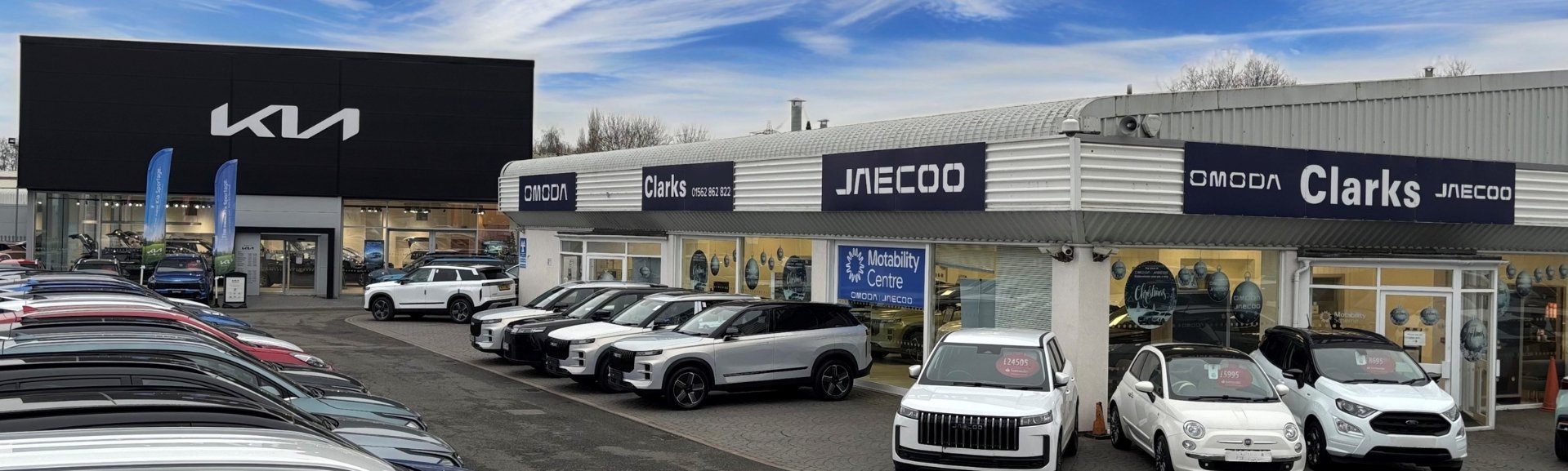 Car dealership with parked cars and Clarks signage above the entrance.