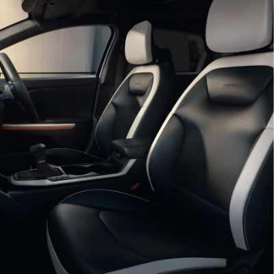 Front seats of a modern car with black and white leather upholstery.
