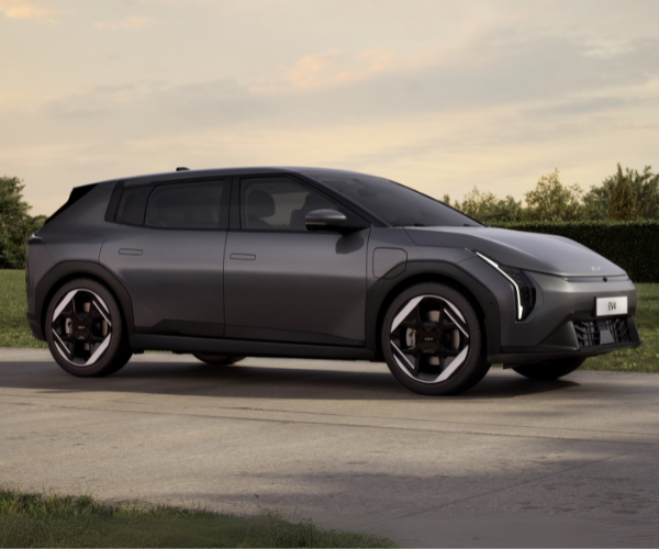 Dark grey modern car parked on a road.