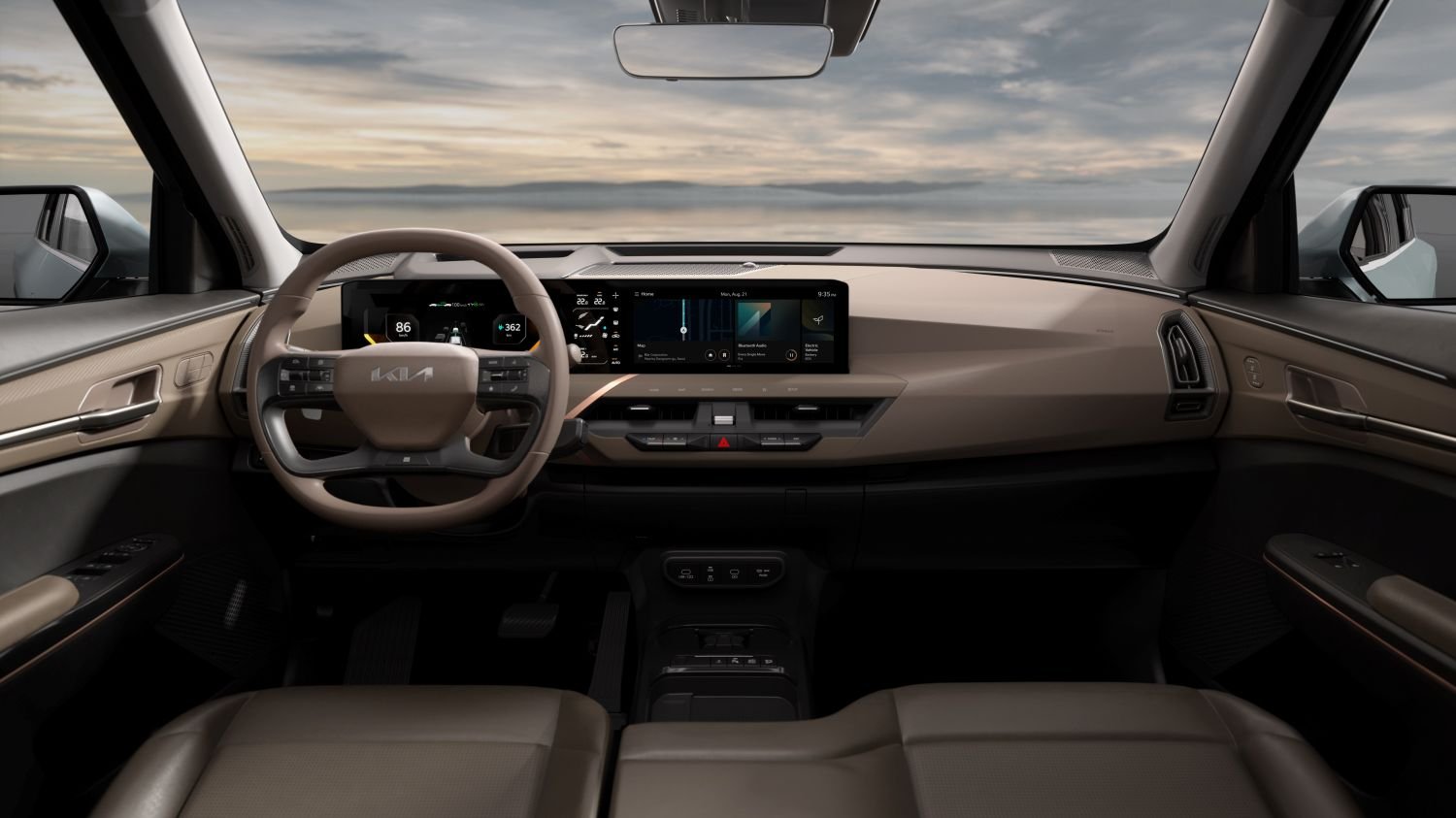 Car interior showing steering wheel and digital dashboard display.