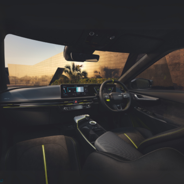 Car interior with modern dashboard and steering wheel, featuring a digital display screen.