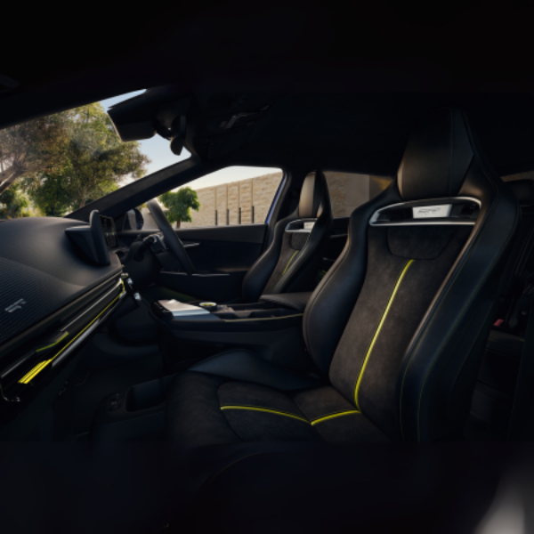 Black and yellow car interior with sports seats and steering wheel.