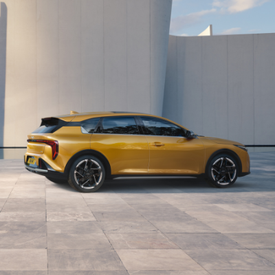 Yellow hatchback car shown from the side on a tiled surface.