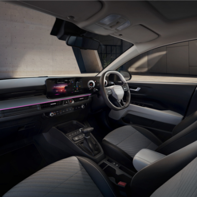 Interior view of a car showing the dashboard, steering wheel, and seats.