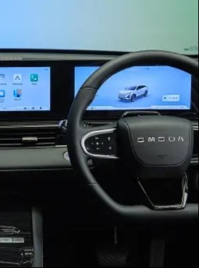 Car dashboard with dual screens and a steering wheel.