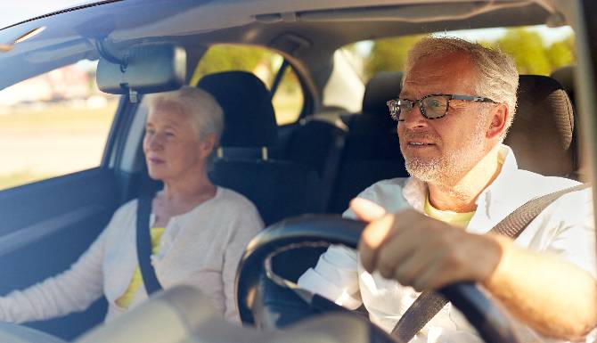 Pensioner couple driving a car